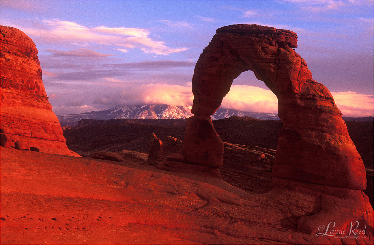 Delicate Arch Cloud Capped La Sal Mountains - © Laurie Reed Photography